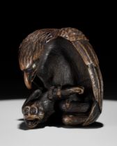 NOBUKAZU: A FINE WOOD NETSUKE OF AN EAGLE ATTACKING A MONKEY