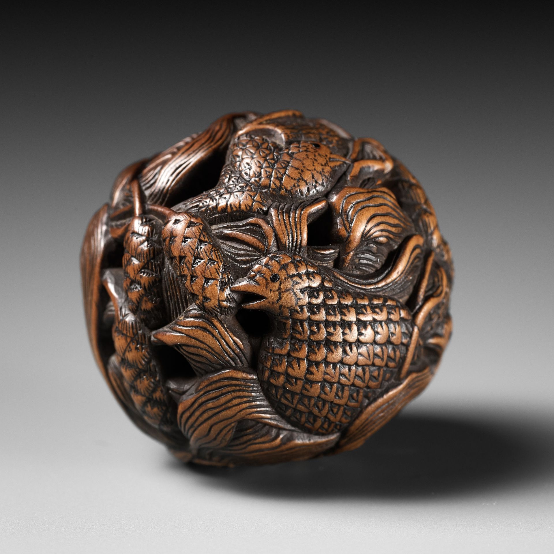 MASANAO: A FINE WOOD NETSUKE DEPICTING AN AUTUMNAL SCENE OF QUAILS AND MILLET