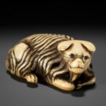 A RARE IVORY NETSUKE OF A JAKONEKO (MUSK CAT)