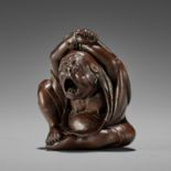 KOMIN: A SUPERB WOOD NETSUKE OF DARUMA YAWNING