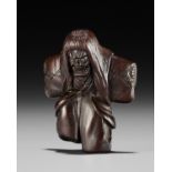 A DRAMATIC WOOD NETSUKE OF A NOH DANCER, ATTRIBUTED TO MIWA