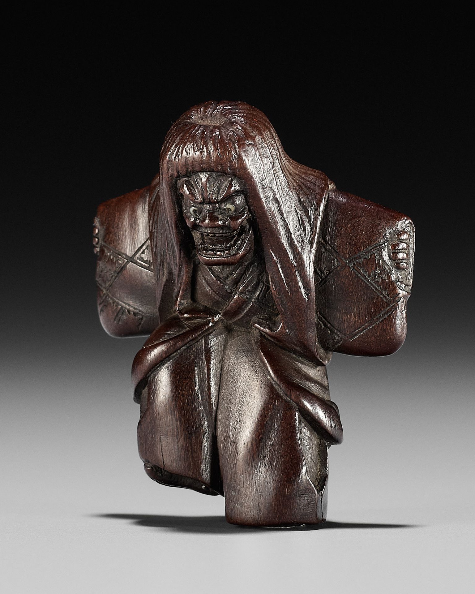 A DRAMATIC WOOD NETSUKE OF A NOH DANCER, ATTRIBUTED TO MIWA