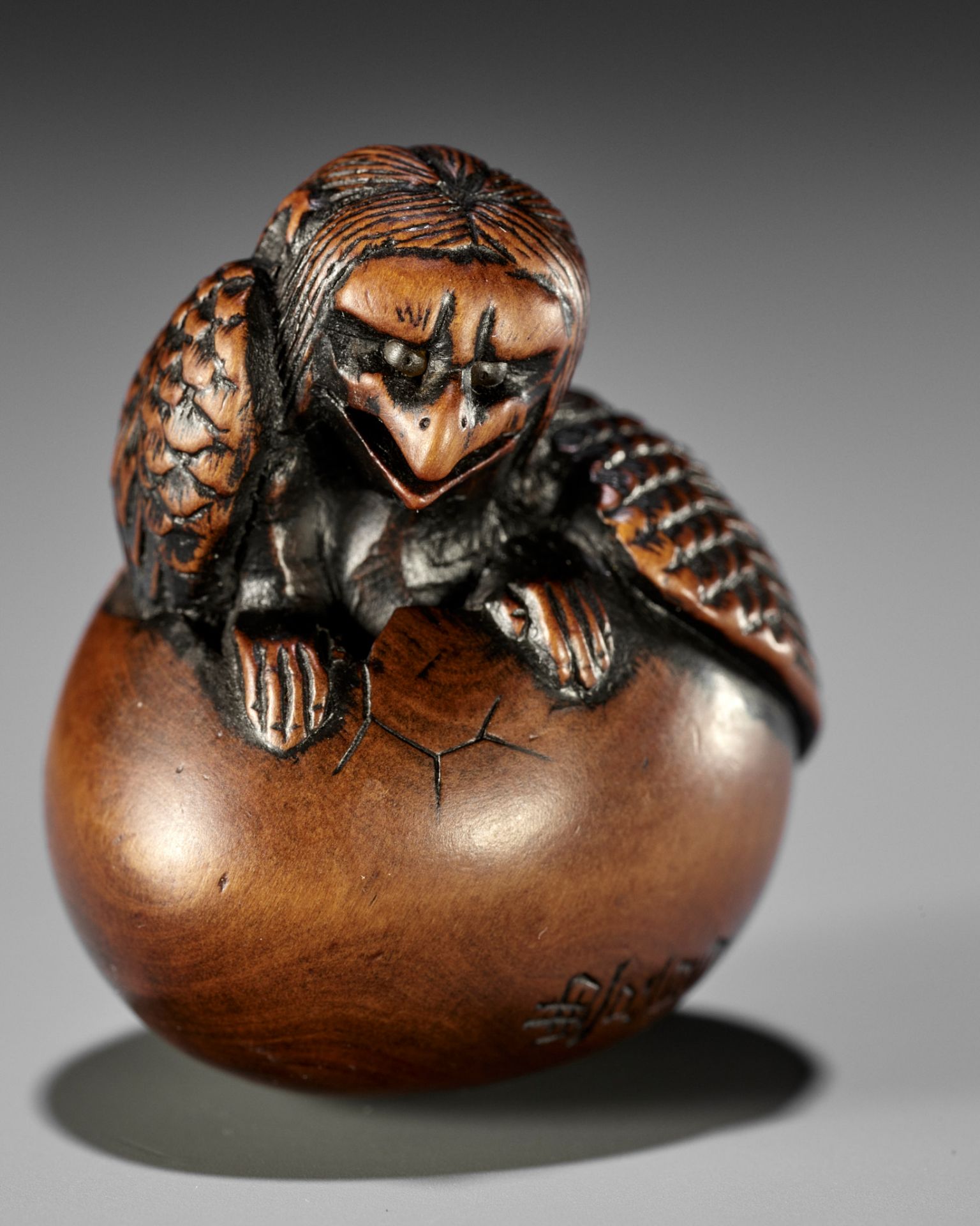 NAITO TOYOMASA: A FINE WOOD NETSUKE OF A HATCHING TENGU (TENGU NO TOMAGO)