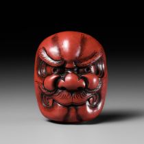 HOMIN: A FINE TSUISHU LACQUER MASK NETSUKE OF AN ONI