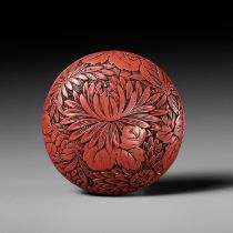 A FINE TSUISHU (CARVED RED LACQUER) MANJU NETSUKE WITH CHRYSANTHEMUMS