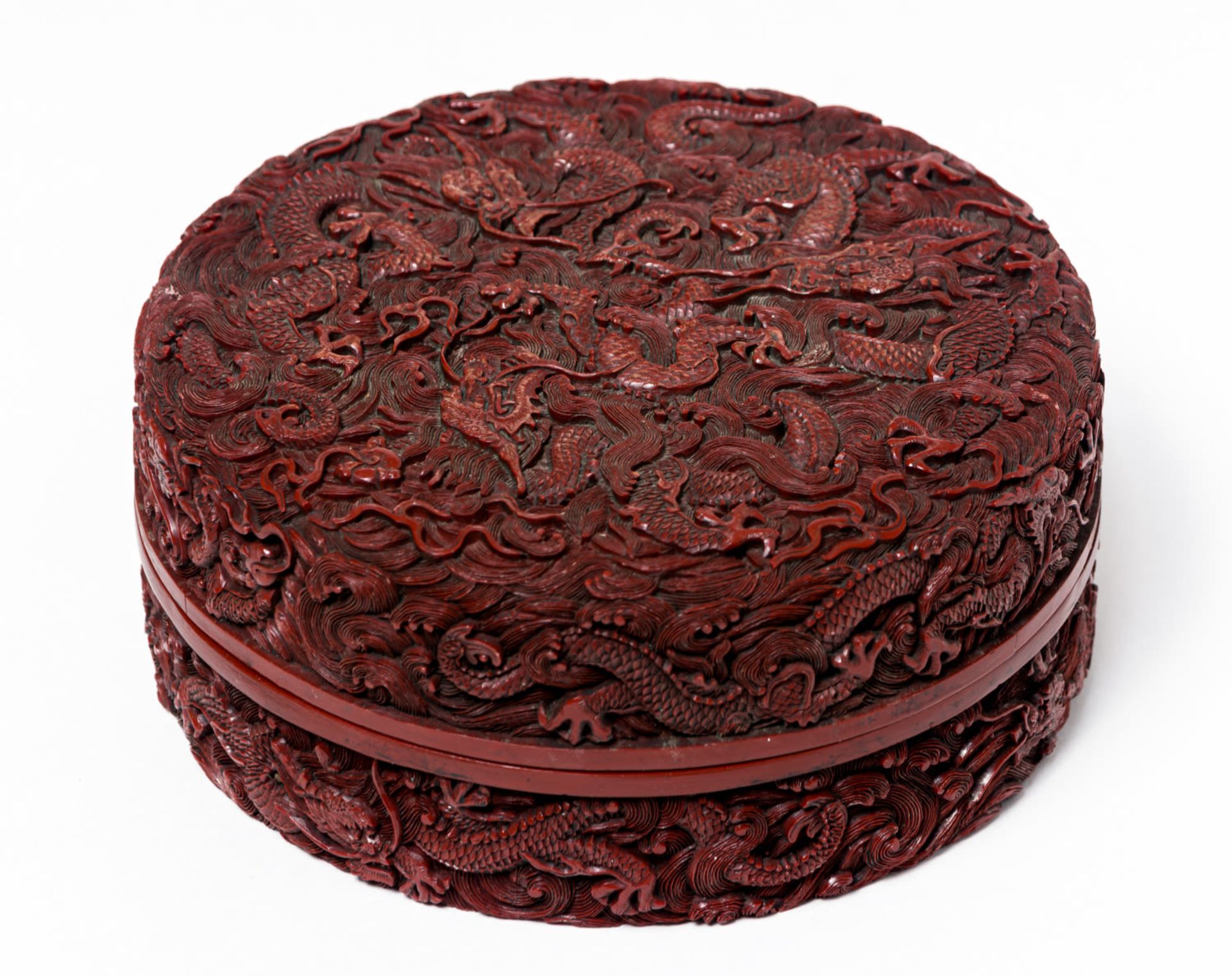 A CHINESE WOOD CARVED CINNABAR LACQUER BOX WITH 9 DRAGONS AND CH'IEN LUNG MARK