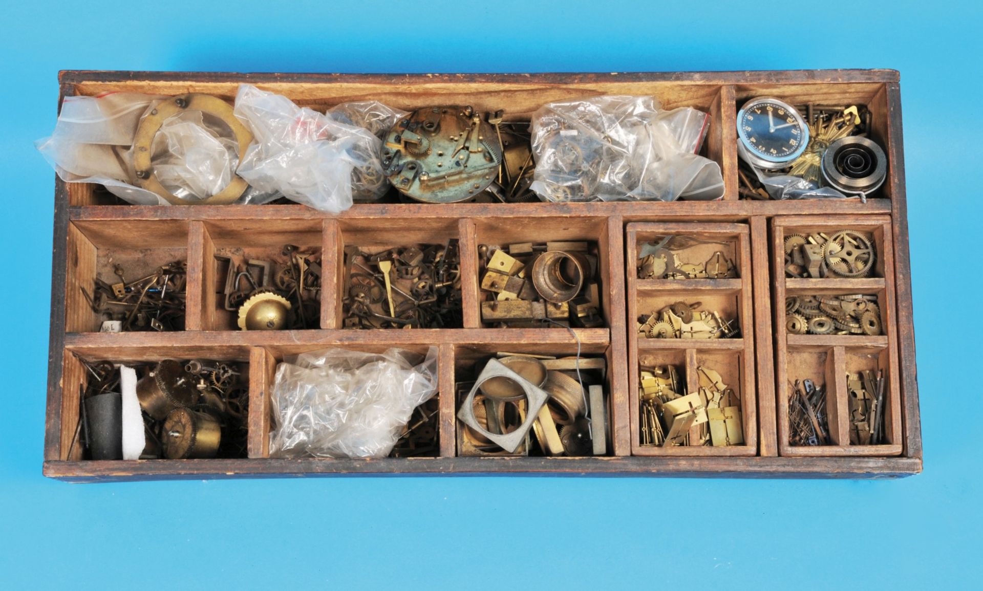 Mixed lot of small brass parts in wooden box