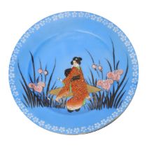 Japanese blue glazed ceramic plate with depiction of geisha in a flowering field