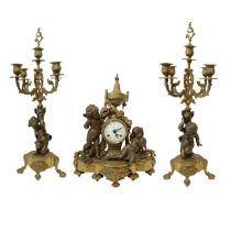 Triptych composed of a table clock in gold patinated bronze with cherubs on the sides, porcelain dia