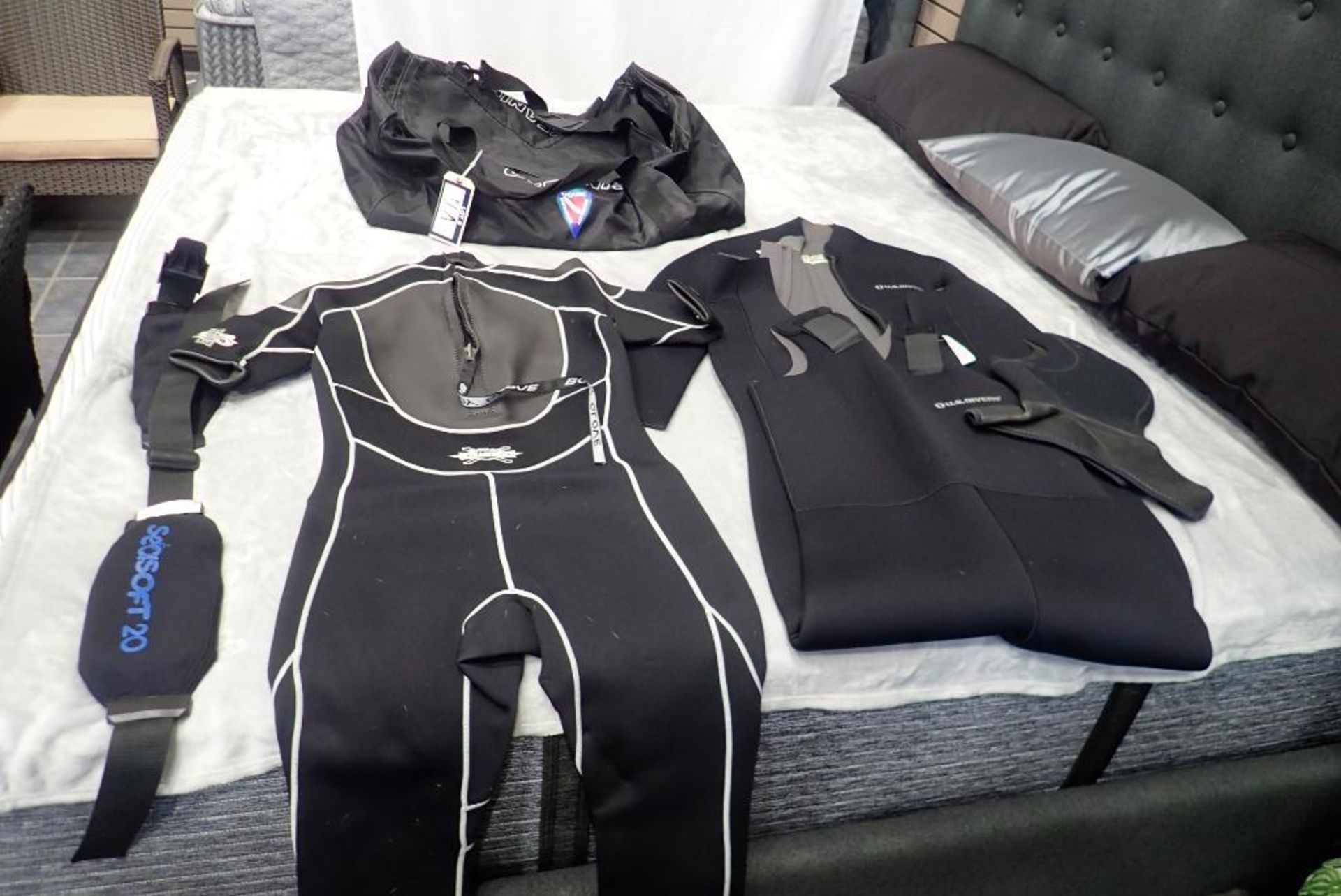 Lot of (2) Wet Suits, Duffle Bag and Weight Belt.