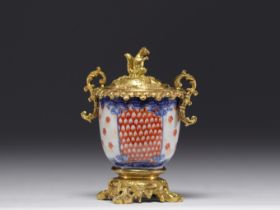 A Chinese porcelain money box with an ormolu squirrel from 18th century