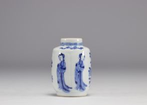 A small white and blue vase decorated with flowers and women in traditional dress from the Kangxi pe