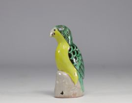 China - Green and yellow glazed ceramic parrot, perched on a rock, Qing period.