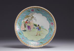 China - Famille rose porcelain plate decorated with figures in a garden, Republic period.