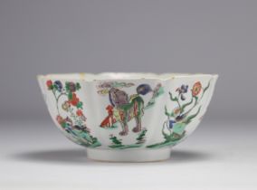A porcelain bowl decorated with flowers and dogs with a mark under the piece, Kangxi period (1661-17