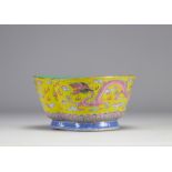 A Famille Rose porcelain bowl decorated with imperial red dragons on a yellow ground with the mark a