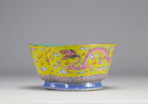 A Famille Rose porcelain bowl decorated with imperial red dragons on a yellow ground with the mark a