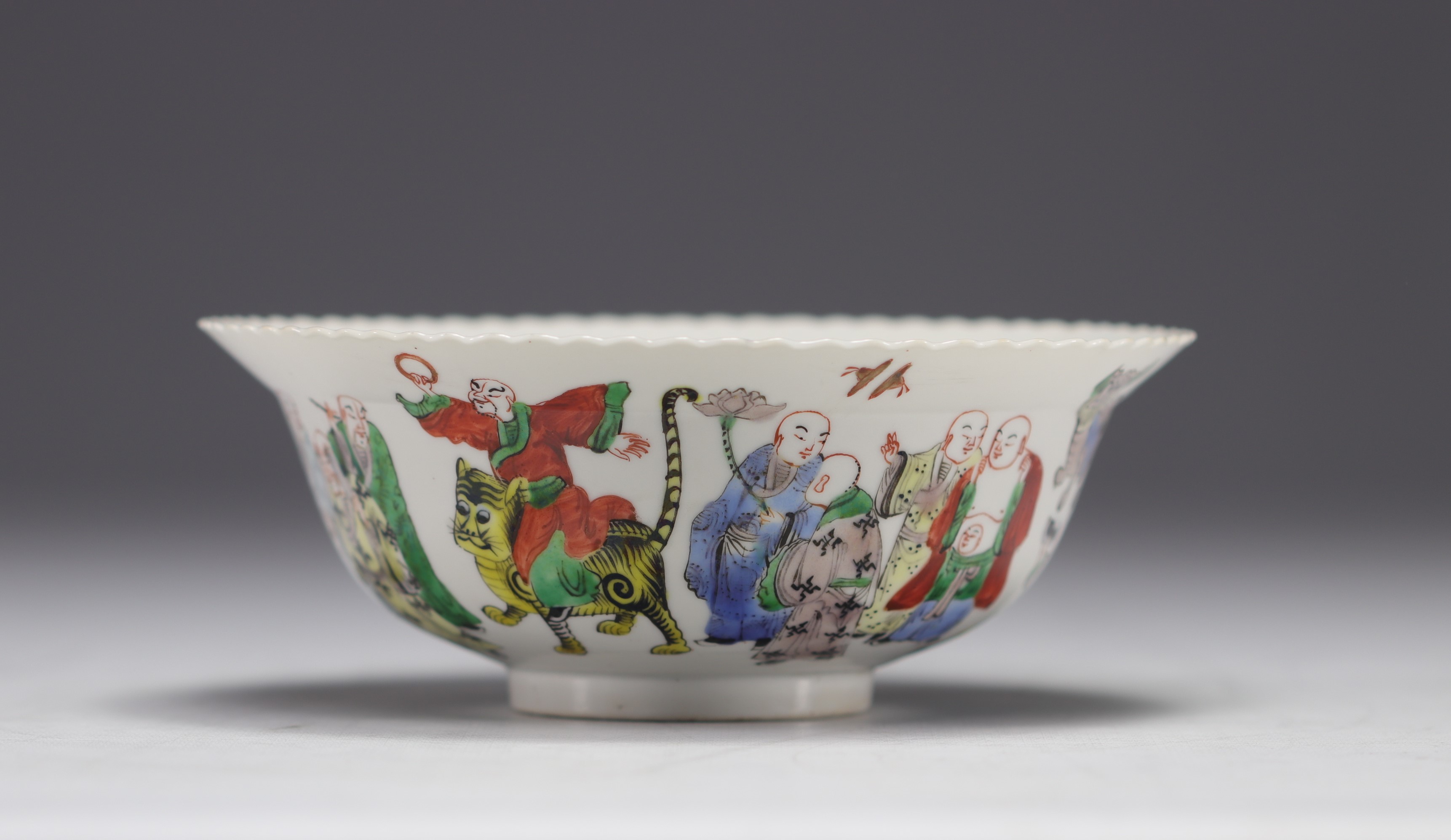 China - Porcelain bowl decorated with frieze of characters, mark in red under the piece.