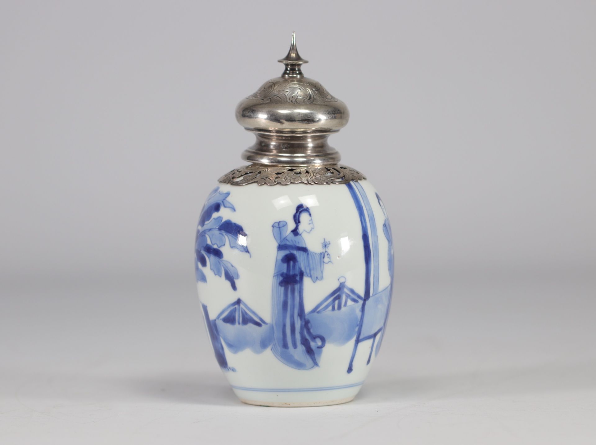 A white and blue vase decorated with women surmounted by a silver stopper with a mark under the piec