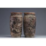 Japan - Pair of stoneware vases decorated with figures and animals, Meiji period.