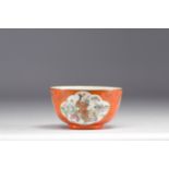 China - An orange porcelain bowl decorated with figures and bats, 19th century.