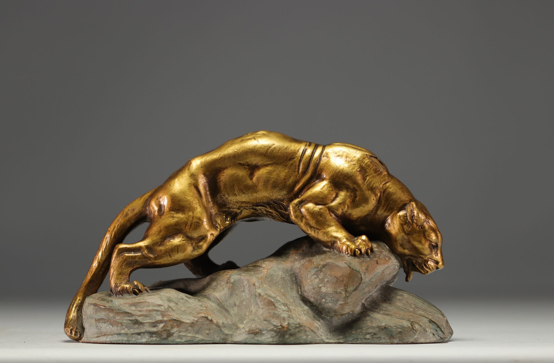 Armand FAGOTTO (19th - 20th century) "Panther stalking on a rock" Terracotta sculpture with golden p