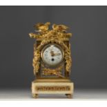Gilt bronze clock decorated with sparrows and garlands of flowers in the Louis XVI style