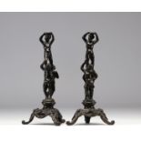 Pair of bronze figures on tripod base.