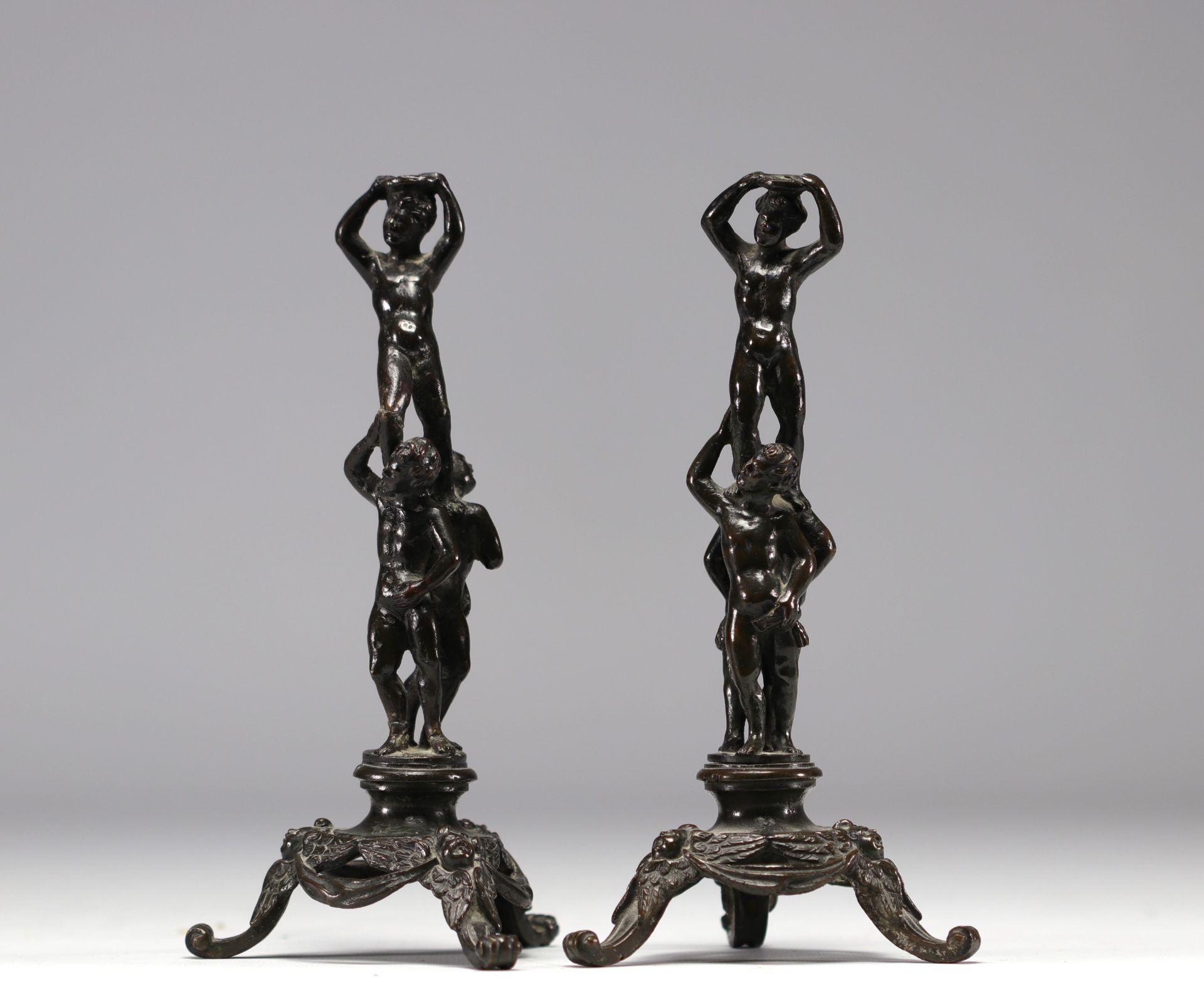 Pair of bronze figures on tripod base.