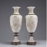 Imposing pair of white vases decorated with angels on a bronze base, 19th century.