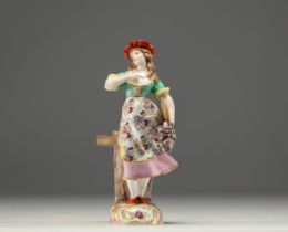 "La paysanne" A polychrome porcelain figurine in the Meissen style.