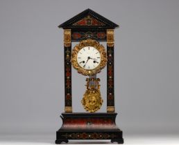 Clock in blackened wood and Boule marquetry from Napoleon III period, 19th century.