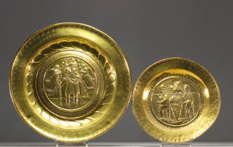 Set of two embossed and repousse brass offering dishes decorated with religious scenes.