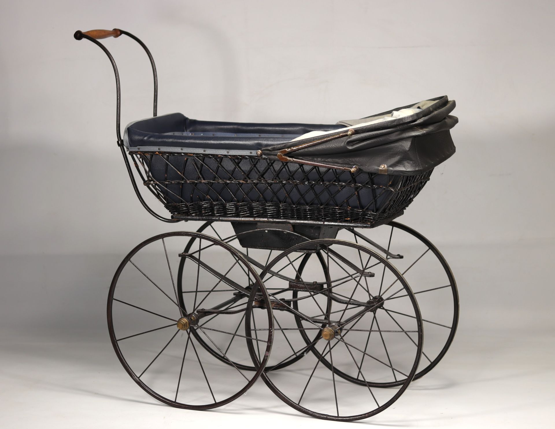 Doll's wicker and wrought iron pram, early 20th century.