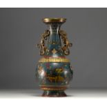 China - A Qing-period cloisonne vase with dragon decoration and bronze handles.