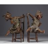 Pair of Babbitt metals "The little rascals" demontrating two little girls having fun on their chairs