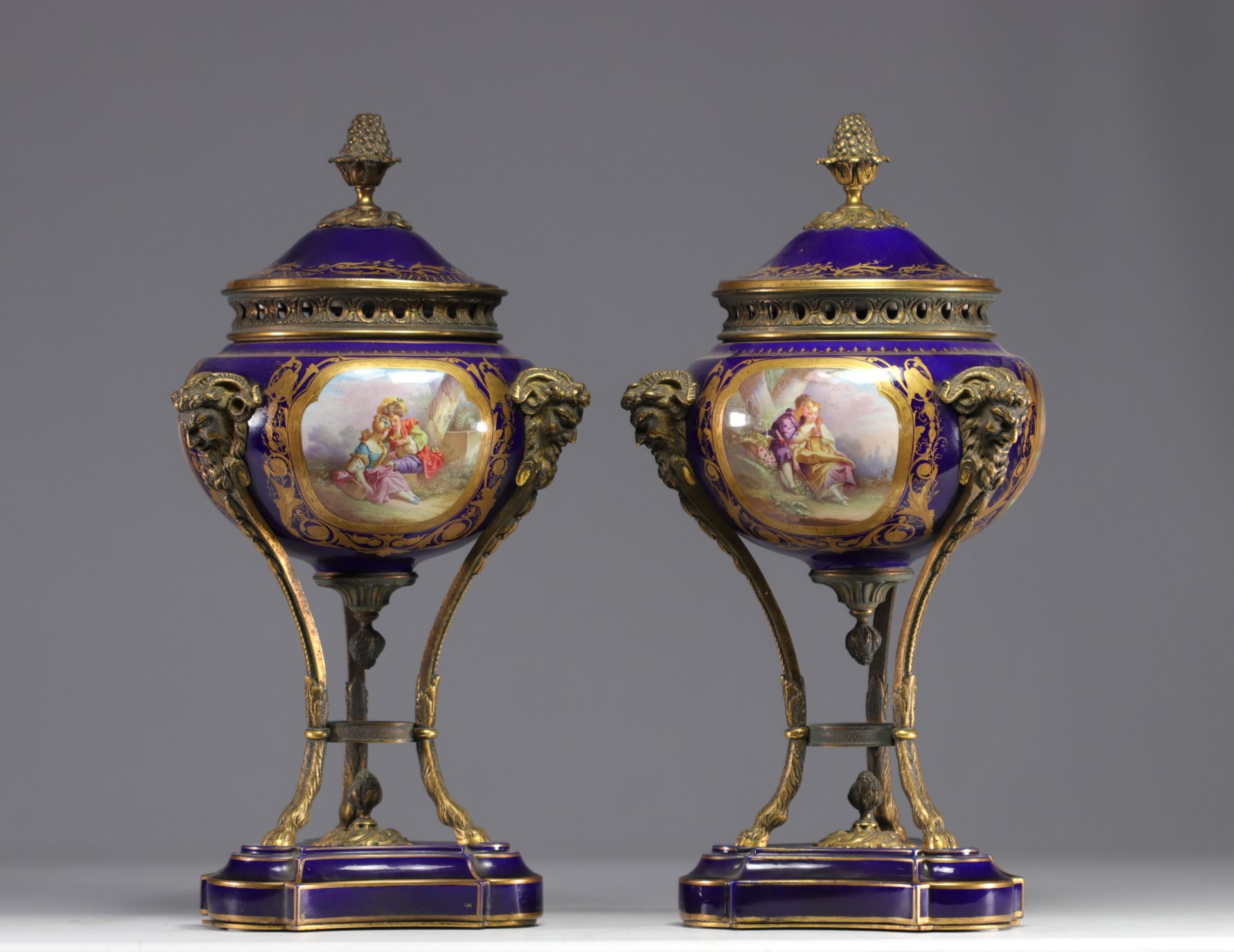 Pair of Sevres porcelain cassolettes decorated with gallant scenes, mounted on bronze.