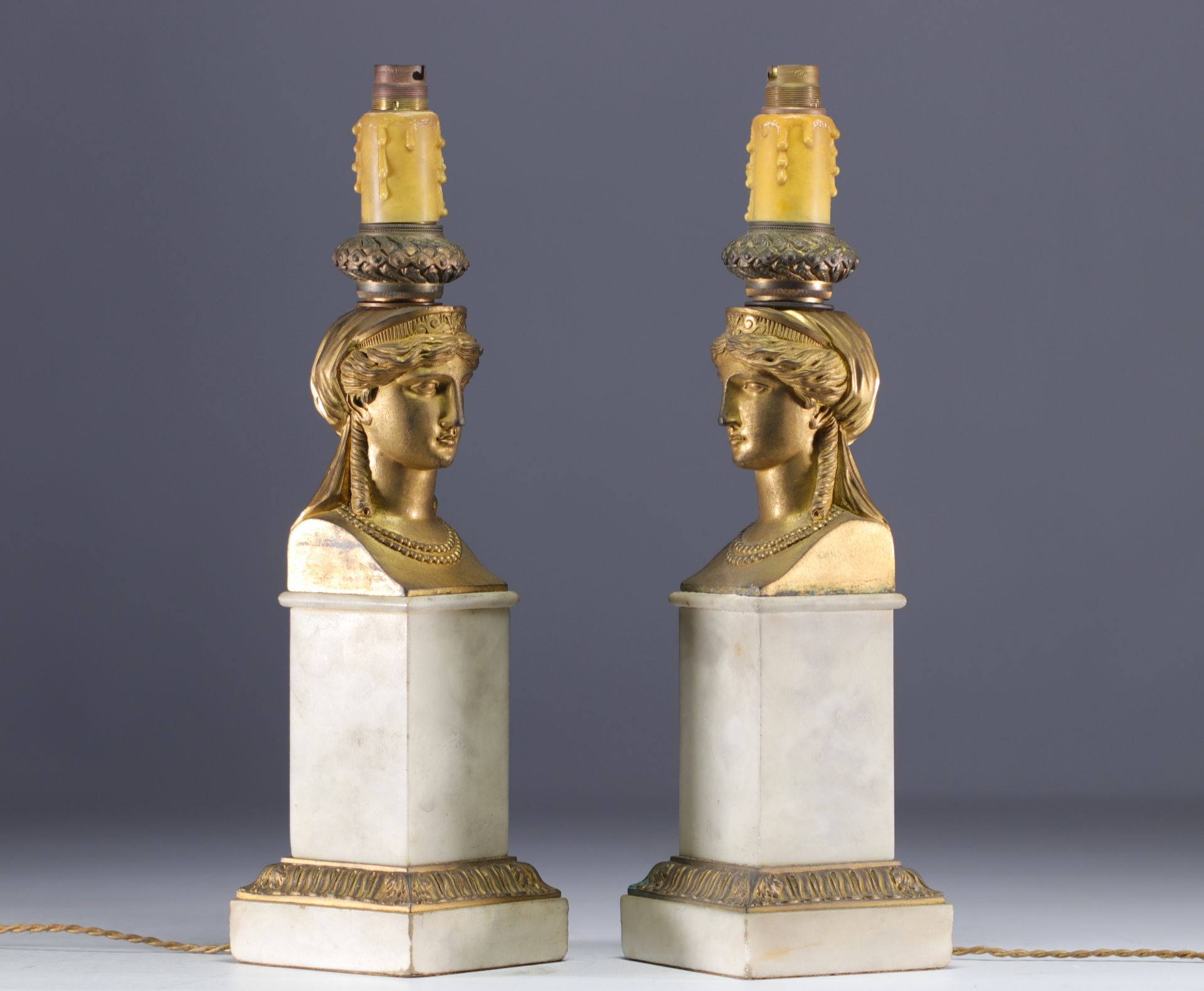 Pair of white marble and gilt bronze lamps with Caryatid faces, Empire period.