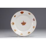 White porcelain plate decorated with gold royal crowns.