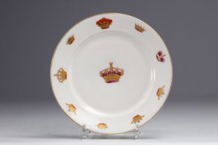 White porcelain plate decorated with gold royal crowns.