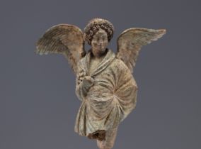 An ancient terracotta angel "fragment" representing Eros, a winged ephebe