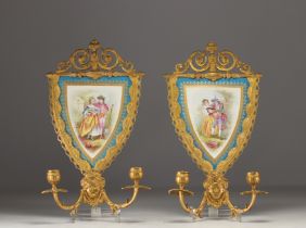 A pair of Sevres porcelain sconces with chased ormolu mounts.