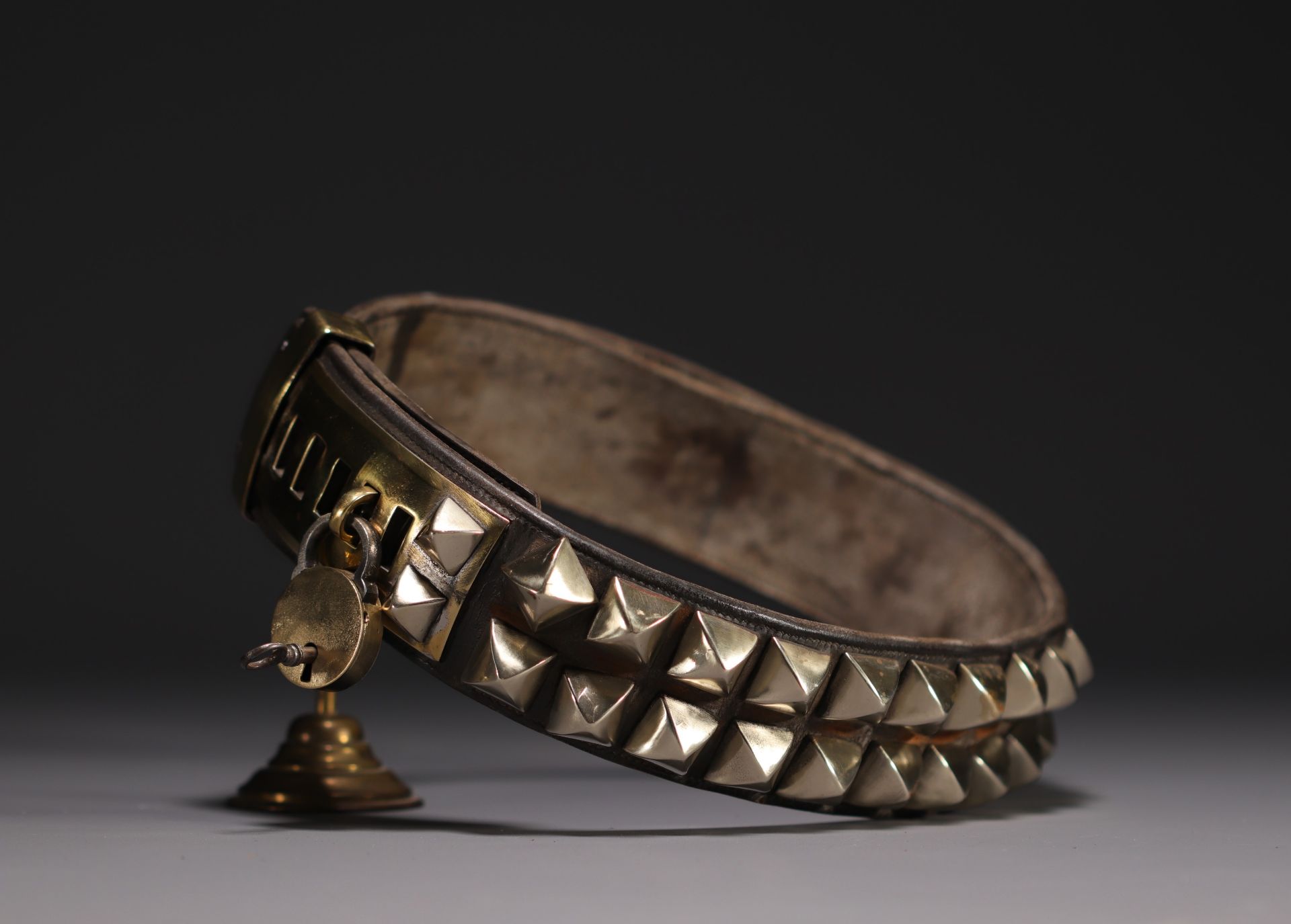 Rare leather dog collar with brass studs and padlock, 19th century.