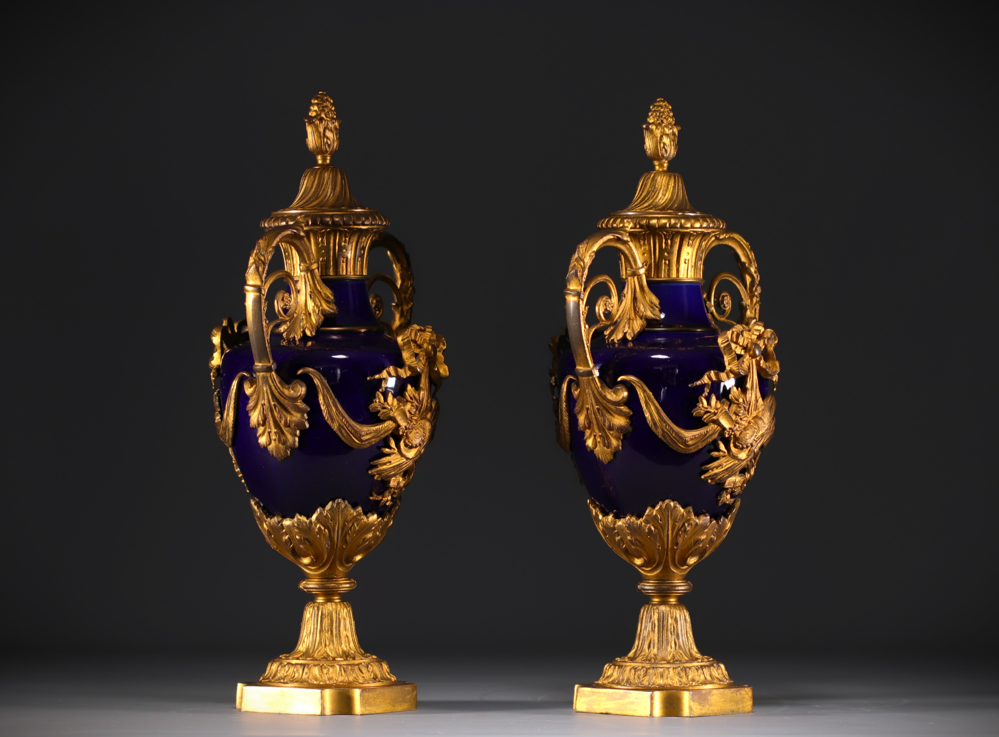 Pair of Louis XVI style covered vases in "bleu de Sevres" porcelain, gilded and chased bronzes. - Image 2 of 3