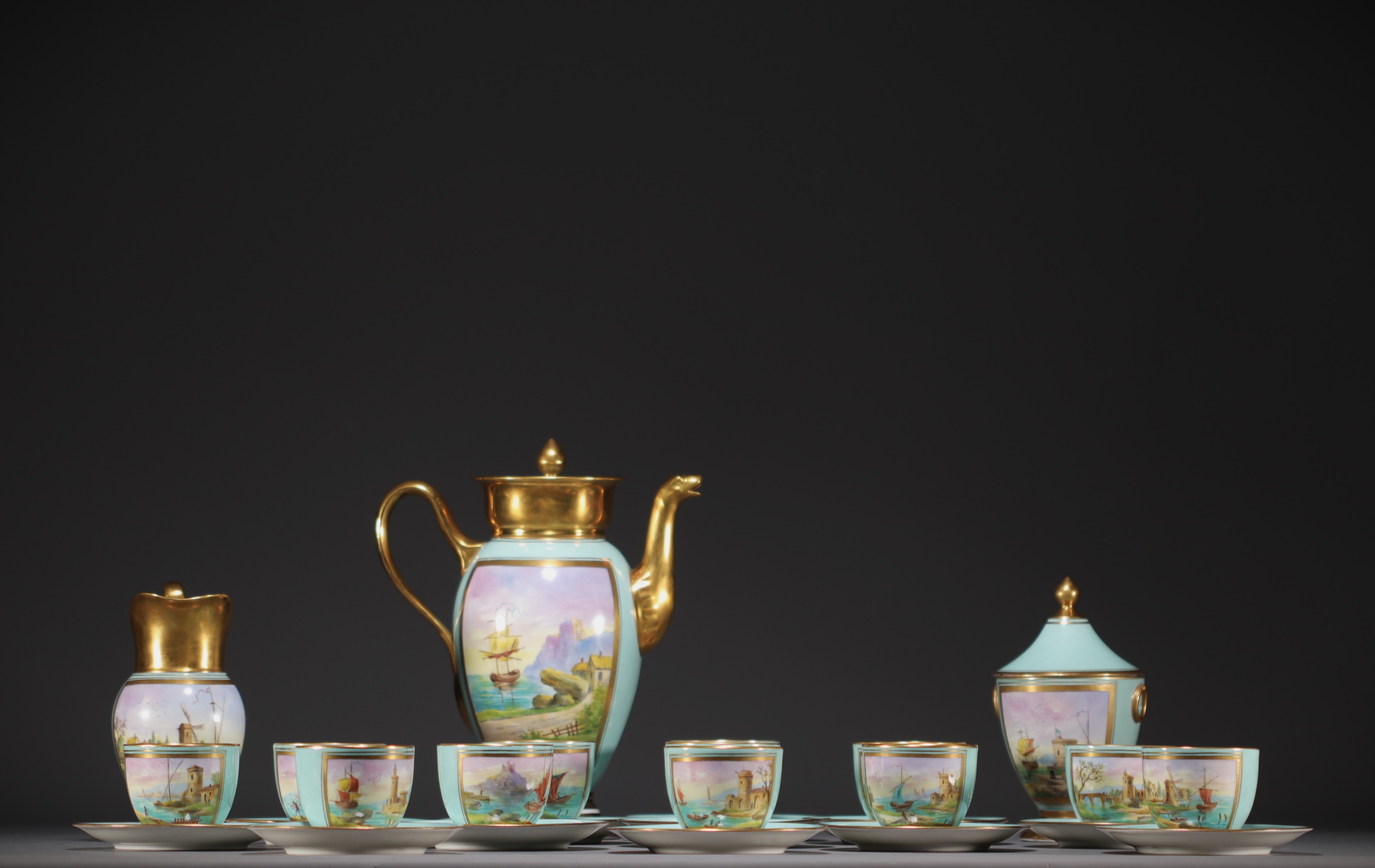 Sevres - A 19th century porcelain coffee service decorated with a marine scene.