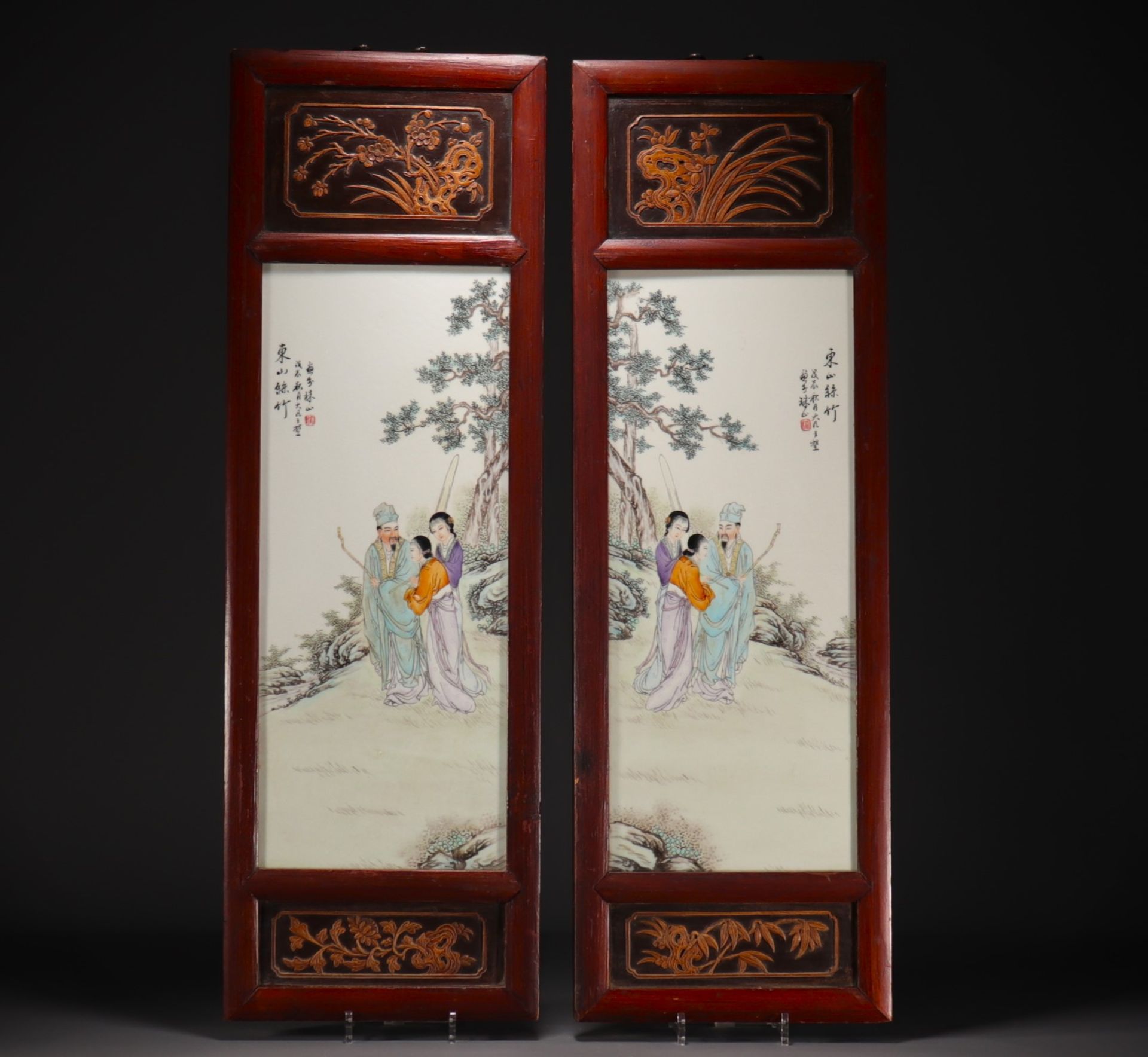 China - Pair of porcelain and wood panels decorated with characters.