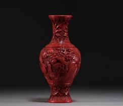 China - An antique cinnabar lacquer vase decorated with figures.