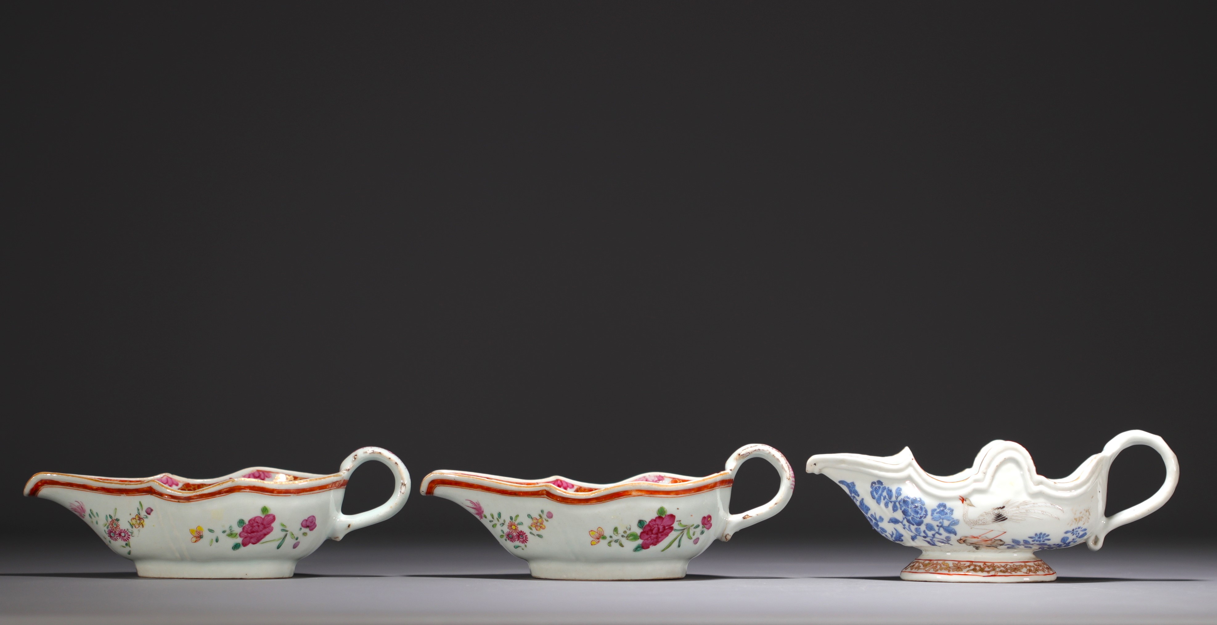 China - Set of three porcelain sauce boats, one blue white and two famille rose, 18th century.