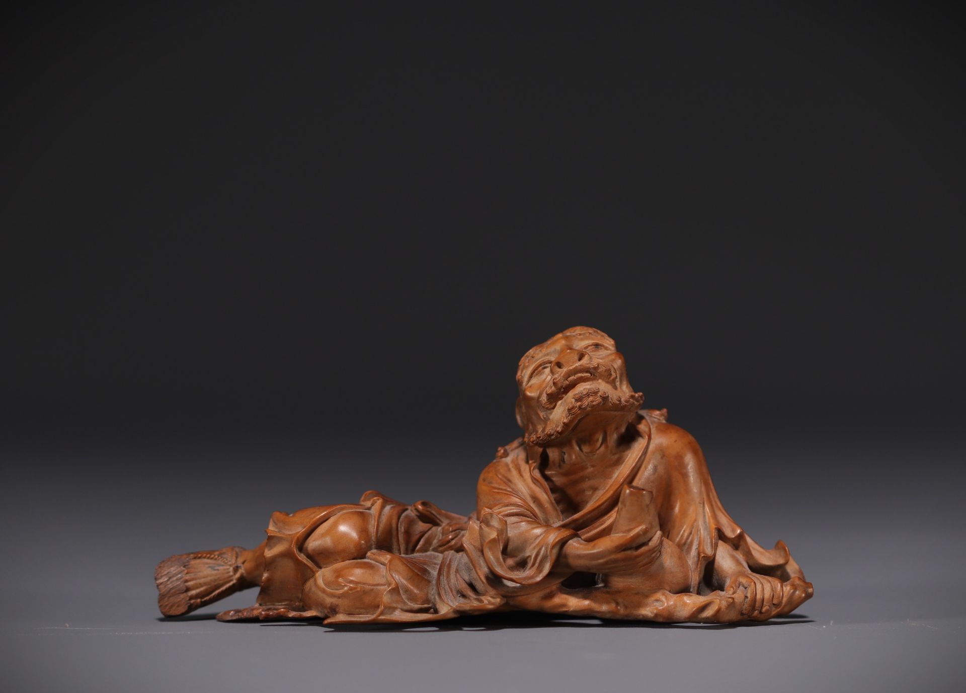 Japan - Boxwood sculpture of a reclining old man, late 19th century.