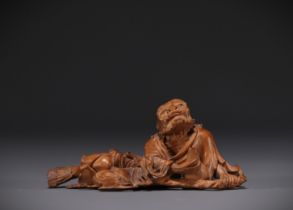 Japan - Boxwood sculpture of a reclining old man, late 19th century.